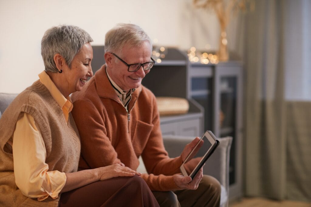 Middle-aged couple using their tablet to do an online course together